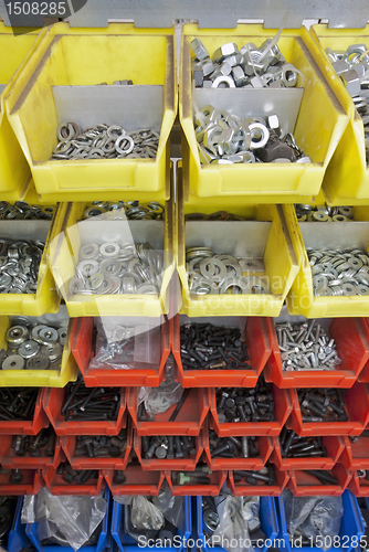 Image of screws and nuts in colored boxes