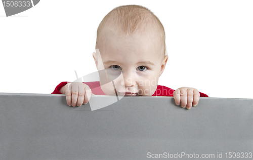 Image of young child holding grey sign