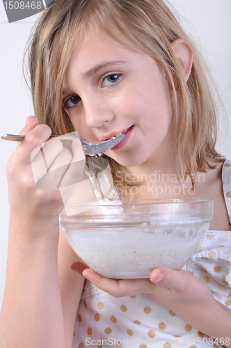 Image of smiling child with a bowl of milk porridge