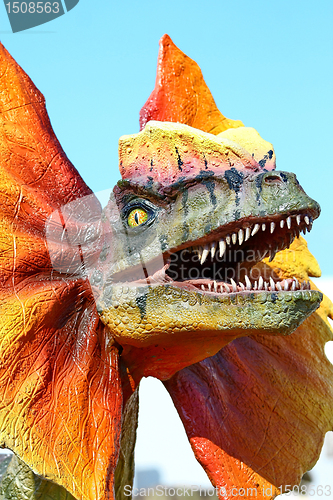 Image of Dilophosaurus dinosaur with orange collar