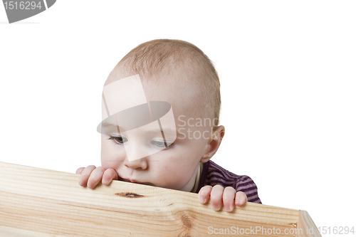 Image of baby looking into wooden box