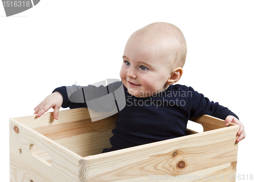 Image of toddler in wooden box