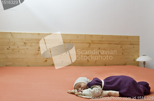 Image of suckling alone in huge bed