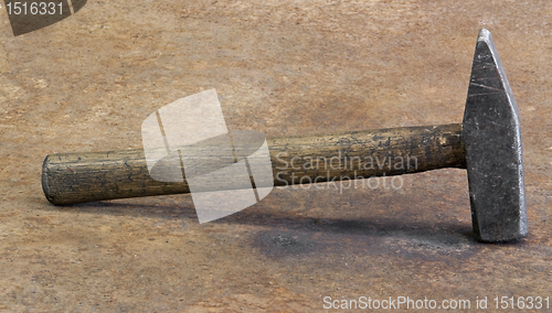 Image of hammer on rusty steel plate