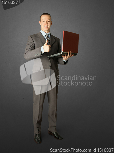 Image of Full length portrait of businessman with laptop