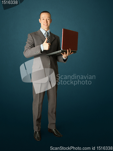 Image of Full length portrait of businessman with laptop