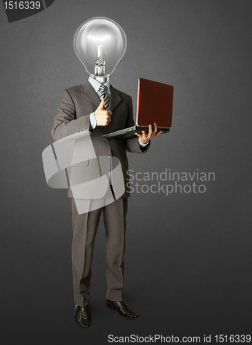 Image of Full length portrait of lamp-head businessman with laptop