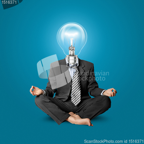 Image of lamp-head businessman in lotus pose