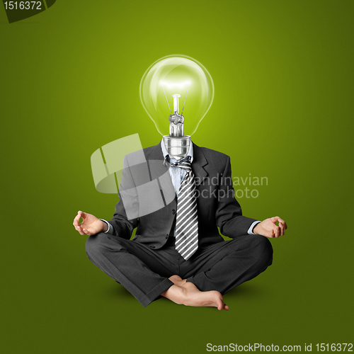 Image of lamp-head businessman in lotus pose