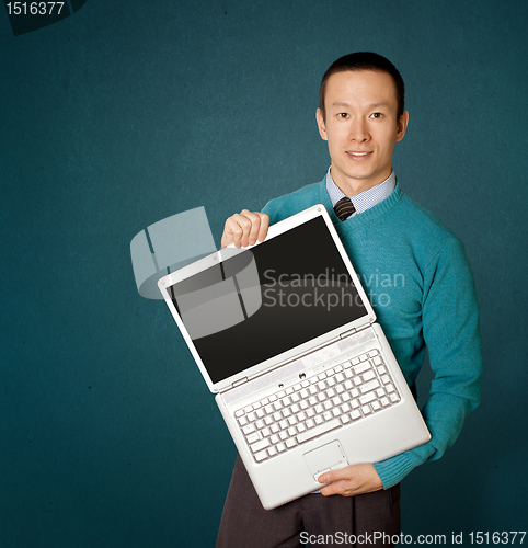 Image of Male in blue with laptop