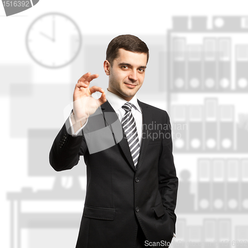 Image of happy businessman in suit shows OK