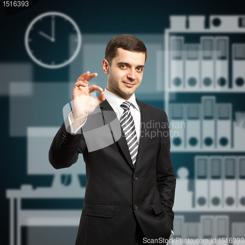 Image of happy businessman in suit shows OK