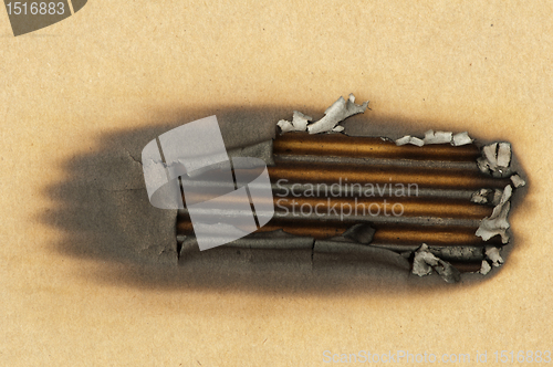 Image of Burned paper and hole