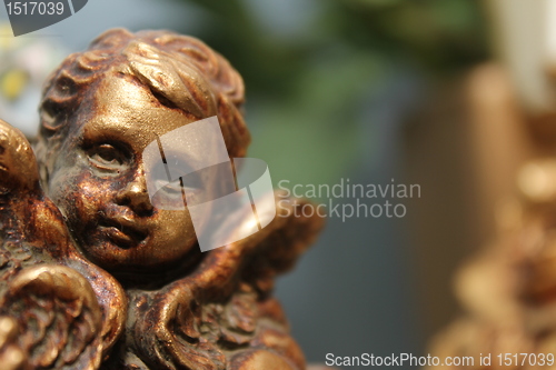 Image of bronze cherub face decoration