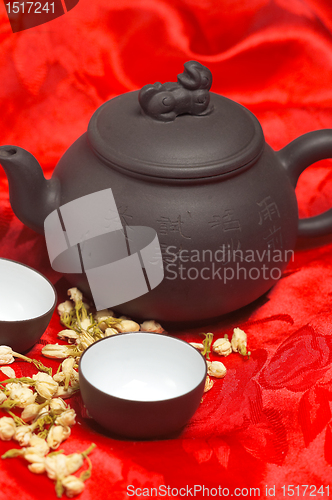 Image of jasmine tea over red silk
