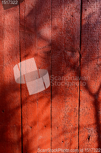Image of Shadows on red-painted wooden wall. 