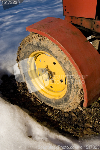 Image of Yellow tractor wheel.