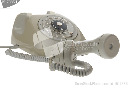 Image of Old vintage rotary style telephone - handset off