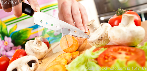 Image of Woman's hands cutting vegetables