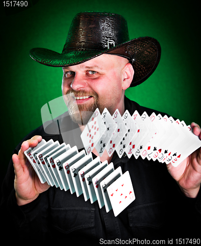 Image of man skilfully shuffles playing cards