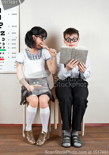 Image of Two person wearing spectacles in an office at the doctor