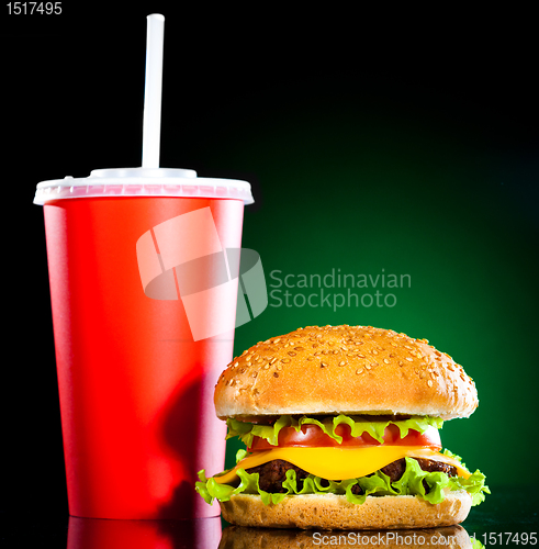 Image of Tasty and appetizing hamburger on a darkly green