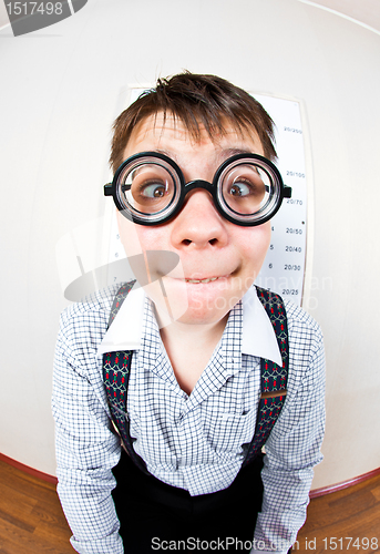 Image of person wearing spectacles in an office at the doctor