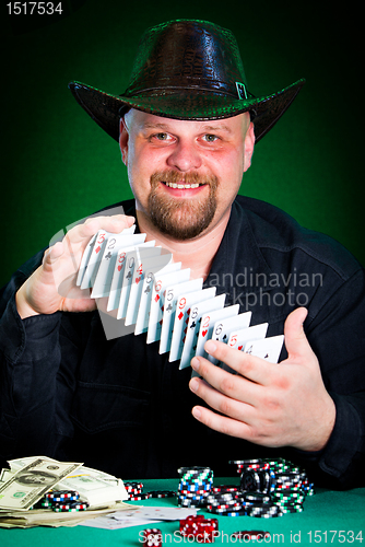 Image of man skilfully shuffles playing cards