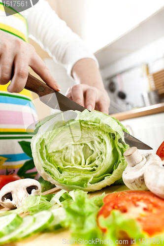 Image of Woman's hands cutting vegetables