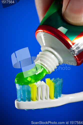 Image of toothpaste being squeezed onto a toothbrush