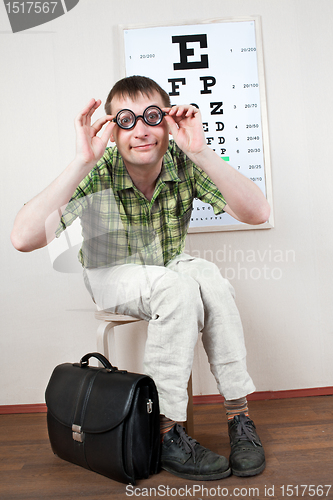 Image of person wearing spectacles in an office at the doctor