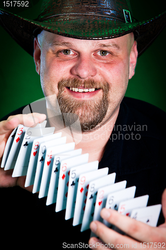 Image of man skilfully shuffles playing cards