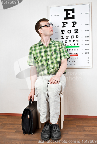 Image of person wearing spectacles in an office at the doctor