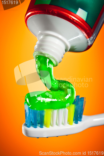 Image of toothpaste being squeezed onto a toothbrush