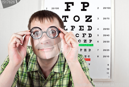 Image of person wearing spectacles in an office at the doctor