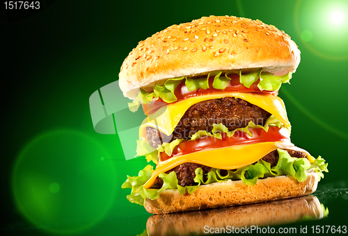 Image of Tasty hamburger and french fries on a dark