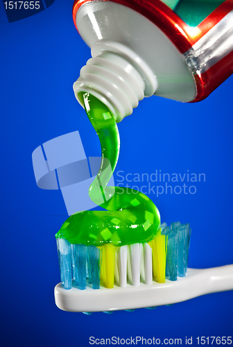 Image of toothpaste being squeezed onto a toothbrush