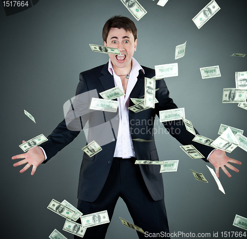 Image of man in a suit throws money