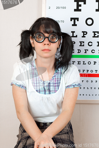 Image of person wearing spectacles in an office at the doctor