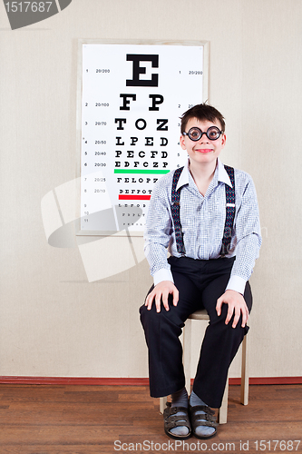 Image of person wearing spectacles in an office at the doctor