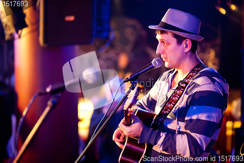 Image of musician plays a guitar