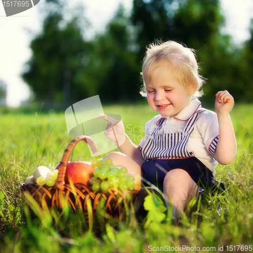 Image of little boy with a basket of fruit