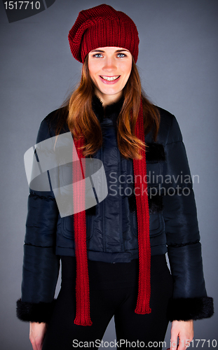 Image of Portrait of the young girl in a winter cap on the dark