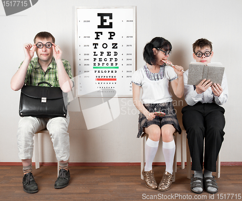 Image of three person wearing spectacles in an office at the doctor