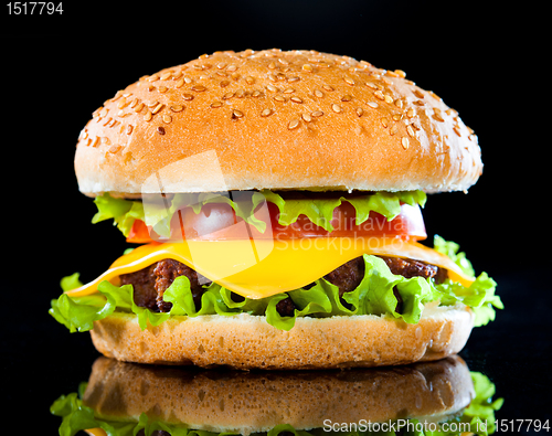 Image of Tasty and appetizing hamburger on a dark