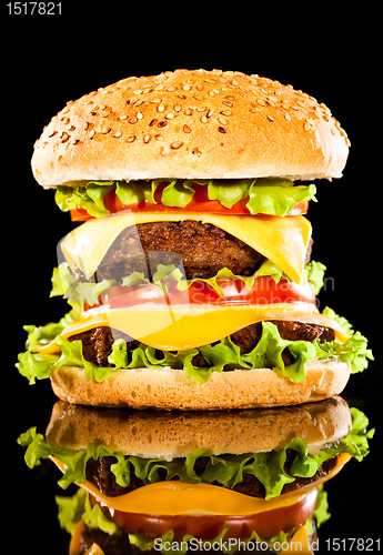 Image of Tasty and appetizing hamburger on a dark