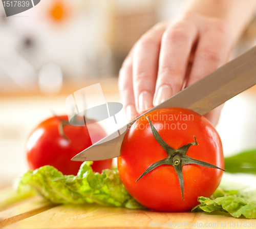 Image of Woman's hands cutting vegetables