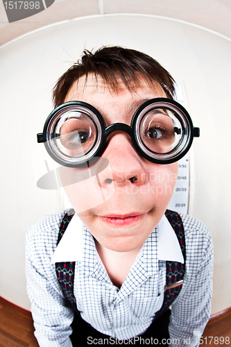 Image of person wearing spectacles in an office at the doctor