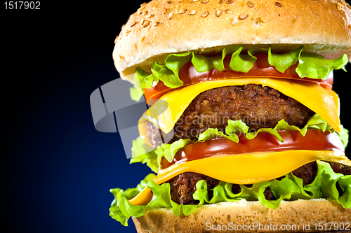 Image of Tasty and appetizing hamburger on a dark blue