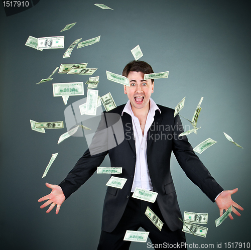 Image of man in a suit throws money